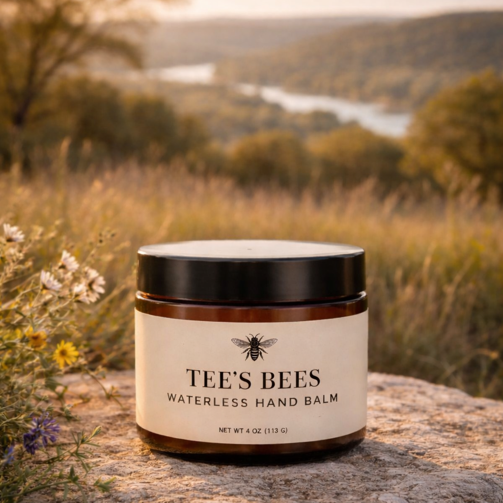 Tee's Bees waterless hand balm jar on a rock with a scenic background